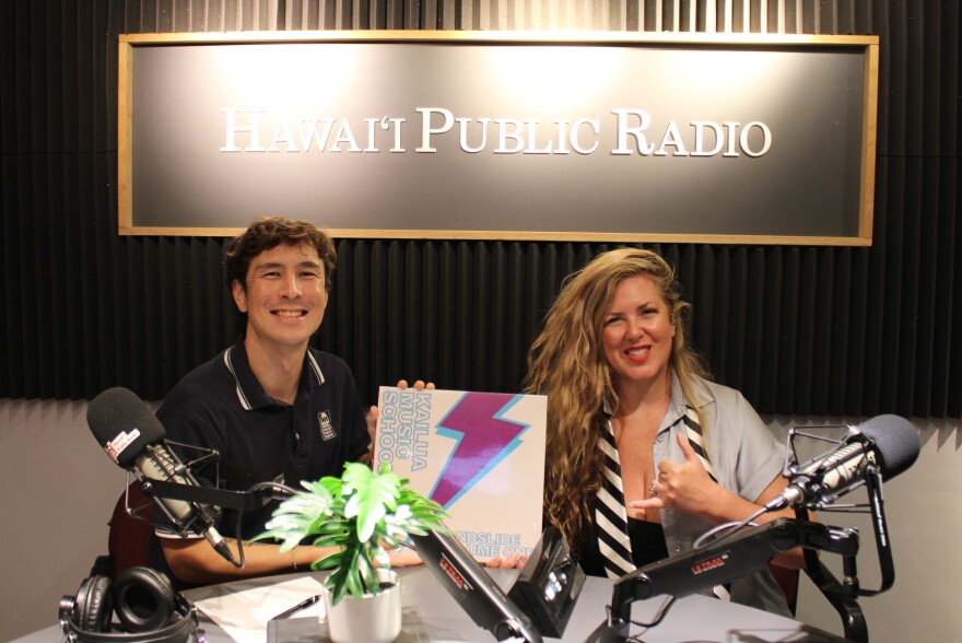 HPR's Kevin Allen, left, with Kailua Music School co-founder Erin Smith, right, holding a vinyl record copy of "Landslide Volume One