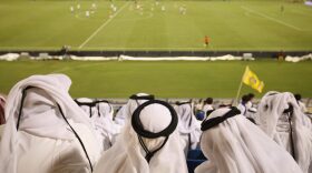 Fans wearing traditional local dress attend the Gharafa vs. Kharaitiyat Qatar Stars League football match at Al Gharafa Stadium in Doha, Qatar.
