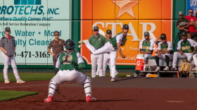 TinCaps players and fans gather to watch Darvish throw his warm-up pitches before the game.