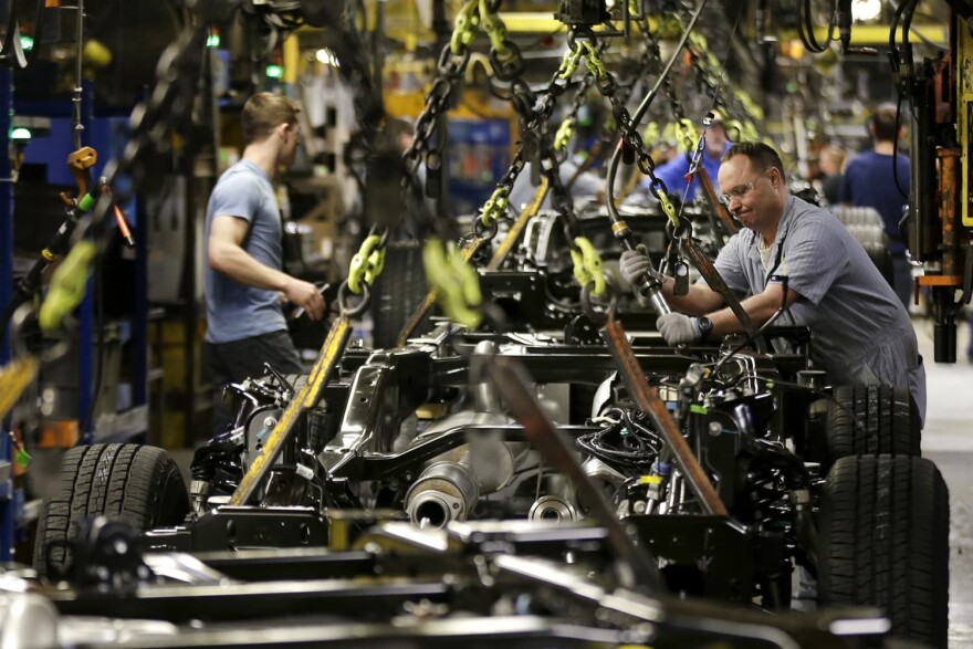  In this March 13, 2015, file photo, a worker prepares a chassis to receive an engine on a new aluminum-alloy body Ford F-150 truck at the company's Kansas City Assembly Plant in Claycomo, Mo. (Charlie Riedel/AP)