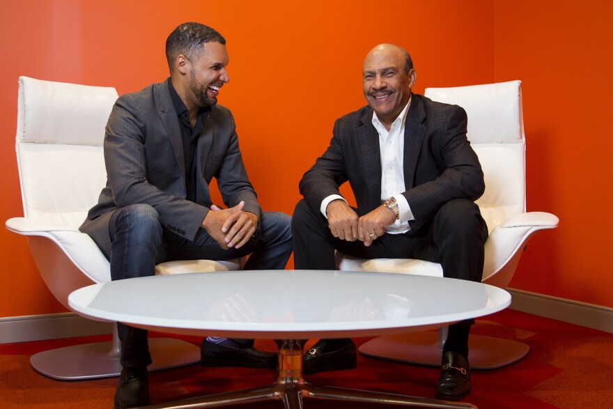KAI Enterprises CEO Michael Kennedy Jr. laughs with his father, Michael Kennedy Sr. (right), who founded the company in 1980.