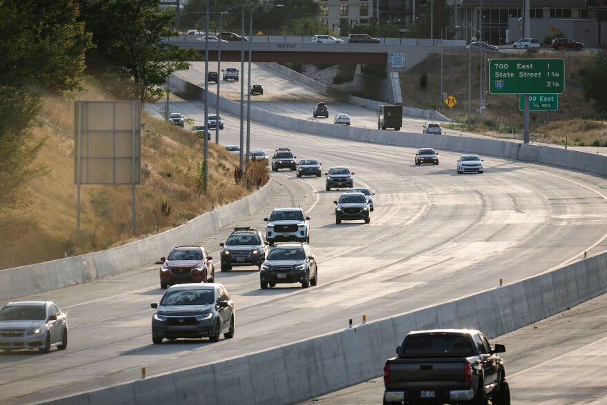 Cars move along I-80 at dusk under the 1300 E overpass in Sugar House, Salt Lake City, Aug. 14, 2026.