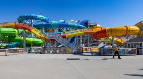 A maintenance worker walks past the water slide at Wicked Waves in Yarmouth as preparations are being made for the upcoming summer season. (Jesse Costa/WBUR)