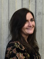 A headshot of Shelby Herbert. She is looking toward the camera and smiling.