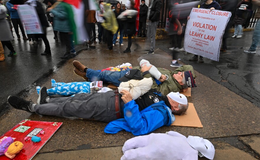 Veterans Mike Fenner and Jack Gilroy lay in front of the Scranton Army Ammunition Plant to block access.