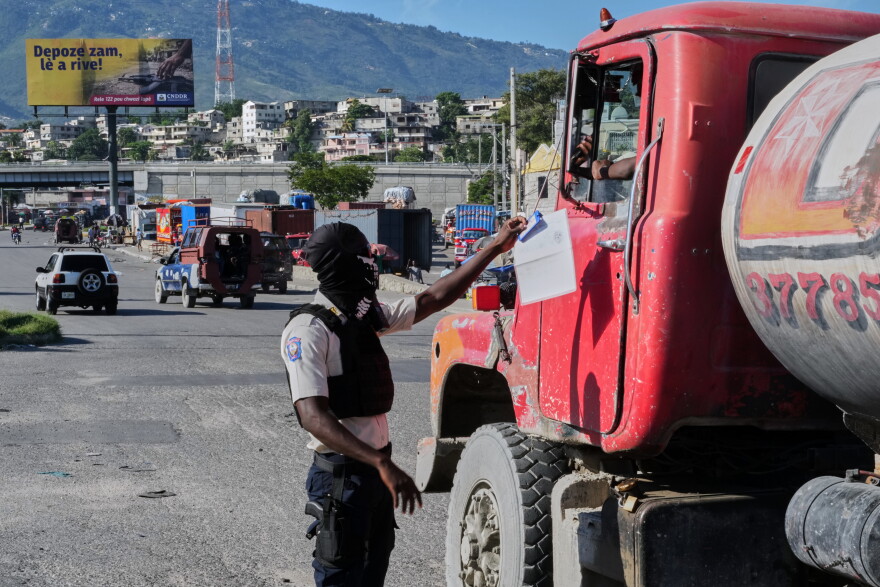 A police officer interacts with a truck driver as he patrols at an intersection in Port-au-Prince, Haiti, Tuesday, Sept. 29, 2026.