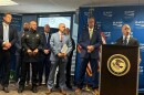 U.S. Attorney for Colorado Peter McNeilly announces a series of indictments in drug and gun cases while federal and local law enforcement officers stand behind him Monday in Denver.
