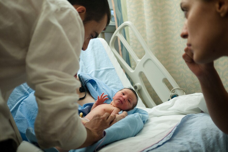 Doctor checks on baby at hosptial