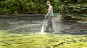 FILE: Pine pollen resembling fallen snow is power-washed in Foxborough, Ma. in 2012.