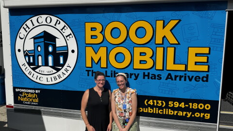 Chicopee librarians Brigitte Lyman and Beth Oliveria with the Chicoppee bookmobile at the Cabot Manor youth center.