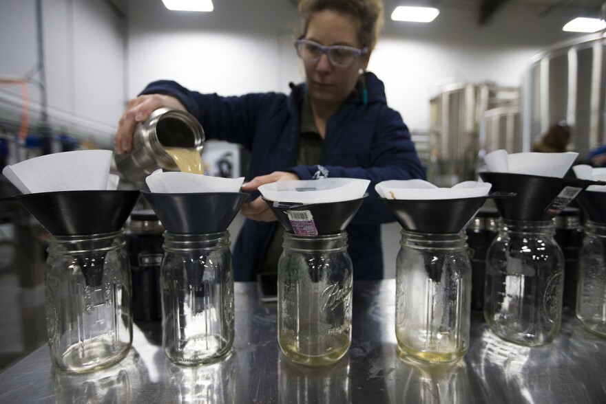 Andrea Stanley of Valley Malt in Hadley, Mass., steeps small amounts of malt as part of the international Pink Boots Collaboration Brew Day, an event meant to highlight women's growing influence on the beer industry.