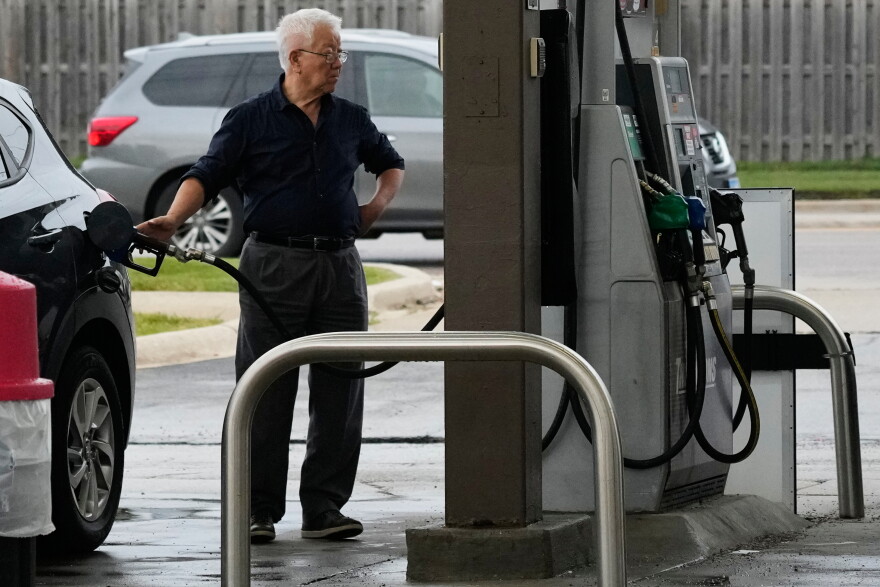 A customer checks gas price while he fills up his vehicle's tank at a gas station, Wednesday, Sept. 16, 2026.