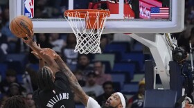 Brooklyn Nets forward Ziaire Williams (1) and New Orleans Pelicans forward Brandon Ingram battle under the basket in the first half of an NBA basketball game in New Orleans, Monday, Nov. 11, 2024. (AP Photo/Gerald Herbert)