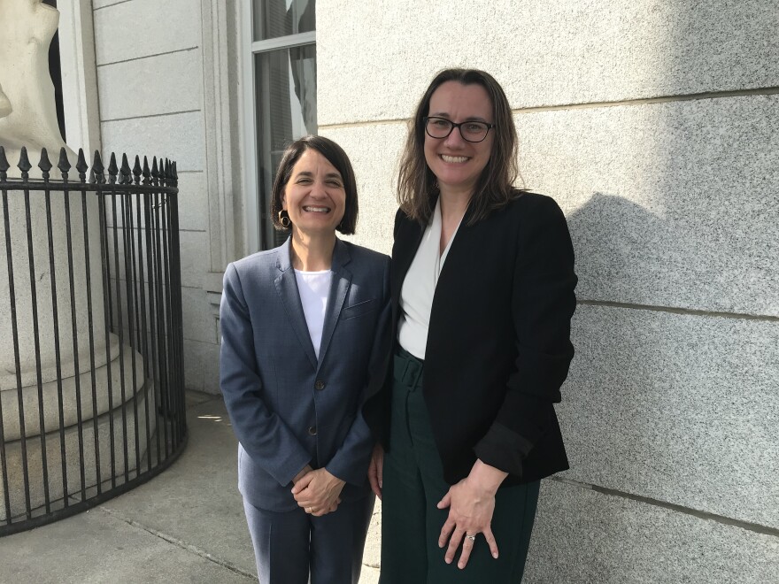 Two women smiling on the steps of the Vermont Statehouse