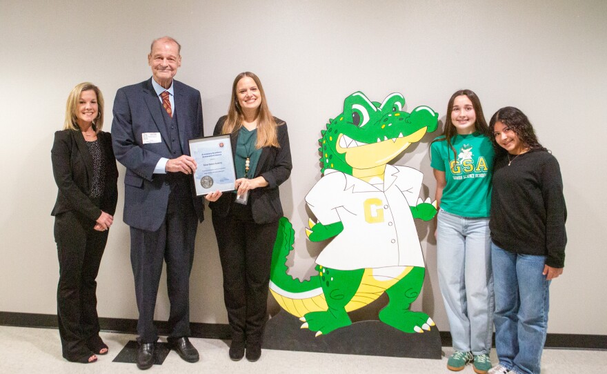 From left to right: GSA Assistant Principal Jamie Elder, Arizona Schools Chief Tom Horne, GSA Principal Jamie Elder, the Gowan gator mascot, and student ambassadors, Taylor Tew and Sophia Delgadillo.