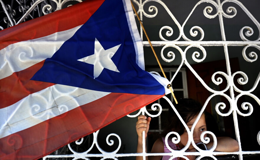 Six-year-old Isabella Breira, daughter of Bianca Noroñas, at the home of her grandfather Felex Camacho in San Juan, Puerto Rico, on July 16, 2021. Determined to find better opportunities for her daughter, Noroñas moved to Connecticut after Hurricane Maria. Four years later, she still feels the pain of leaving.