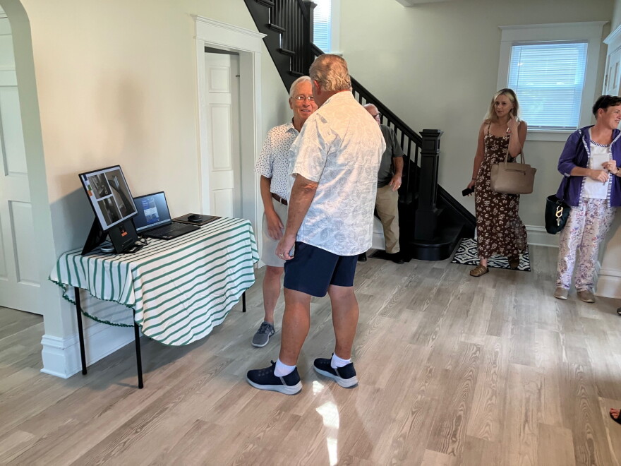 People look through the renovated house and slide shows at 613 W. 13th St., Davenport, on Sept. 8, 2026.