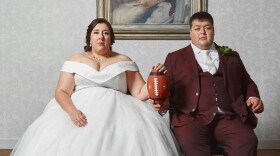 Newlyweds Michelle and Barry de Boer sit for a wedding portrait in the Queens Room of the Fletcher Hotel in Leeuwarden, Netherlands, on Aug. 28, 2021. Michelle, 33, a center for the Amsterdam Cats, and Barry, her offensive line coach, met on the field in 2017 and have been together since April 2018. (Julia Gunther)