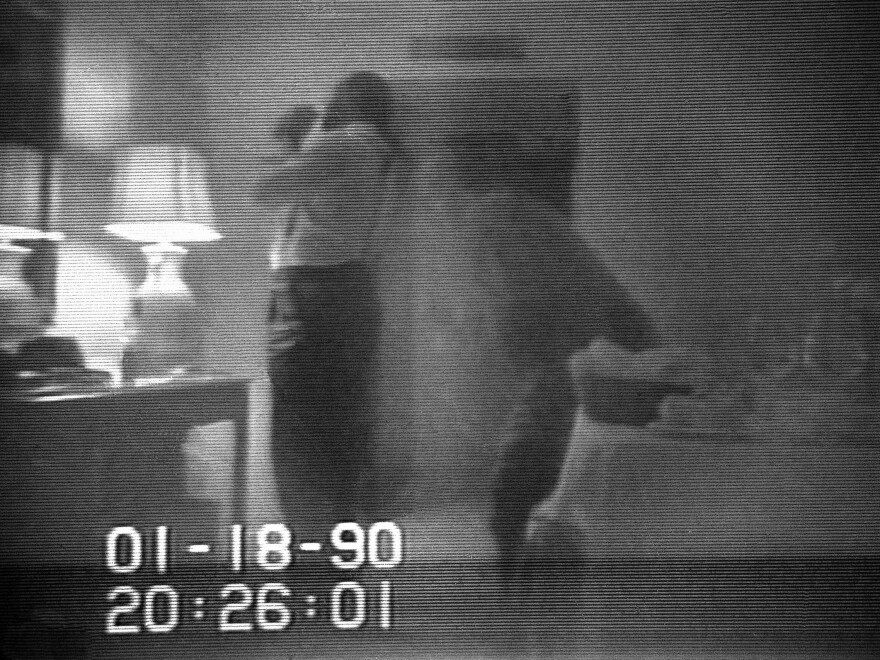 This frame from a black-and-white FBI videotape shows Barry allegedly lighting a crack cocaine pipe in a Washington hotel room in 1990. The video was played repeatedly on television newscasts around the world and used as evidence against Barry.