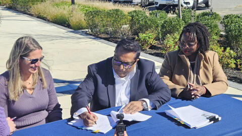 CWDI President Angie Hengst, Pinnacle Hospitality Group President Tauhid Islam and Cambridge Mayor Lajan Cephas Bey sign the Cambridge Harbor hotel agreement