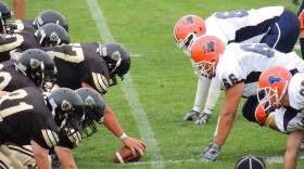 Two football teams face off on a field