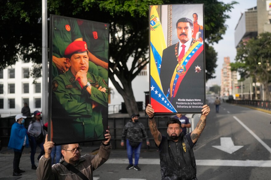 Government supporters display posters of Venezuelan President Nicolás Maduro, right, and former President Hugo Chávez in downtown Caracas, Venezuela, Saturday, Jan. 3, 2026, after U.S. President Donald Trump announced that Maduro had been captured and flown out of the country.