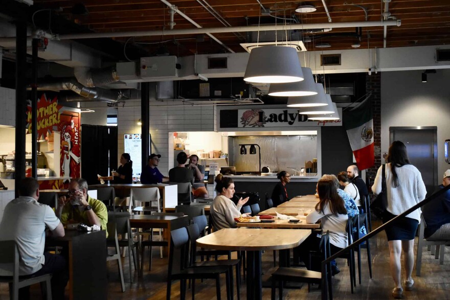 Diners sit inside Parlor KC’s Crossroads food hall the day after the space announced its planned closure.