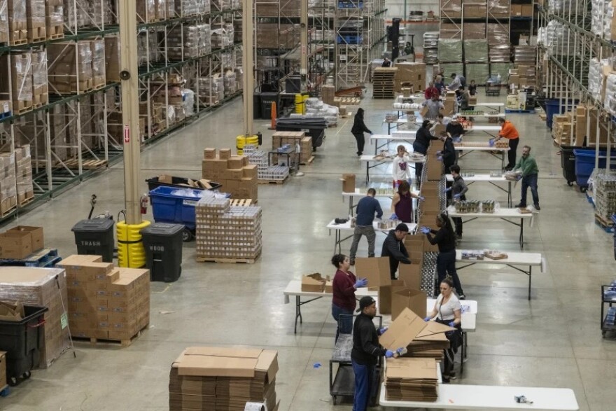 Volunteers help break down and repackage food at the Greater Chicago Food Depository. Trump administration cuts to AmeriCorps would have cost the organization funding.