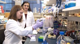 (front) Trisha Wise-Draper, MD in a UC lab, who recently discovered immotherapy cancer treatment can lead to death if mixed with COVID-19.