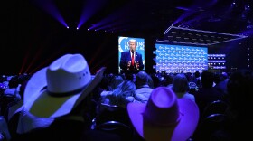 People listen as former President Donald Trump speaks at the Turning Point Action conference, Saturday, July 15, 2023, in West Palm Beach, Fla.