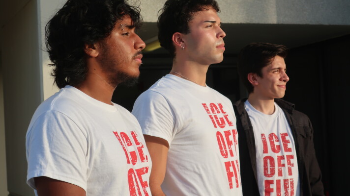 Three men look into the distance with shirts that read "ICE OFF FIU"