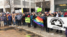 Protesters gather outside the federal building in Rochester on Thursday afternoon.