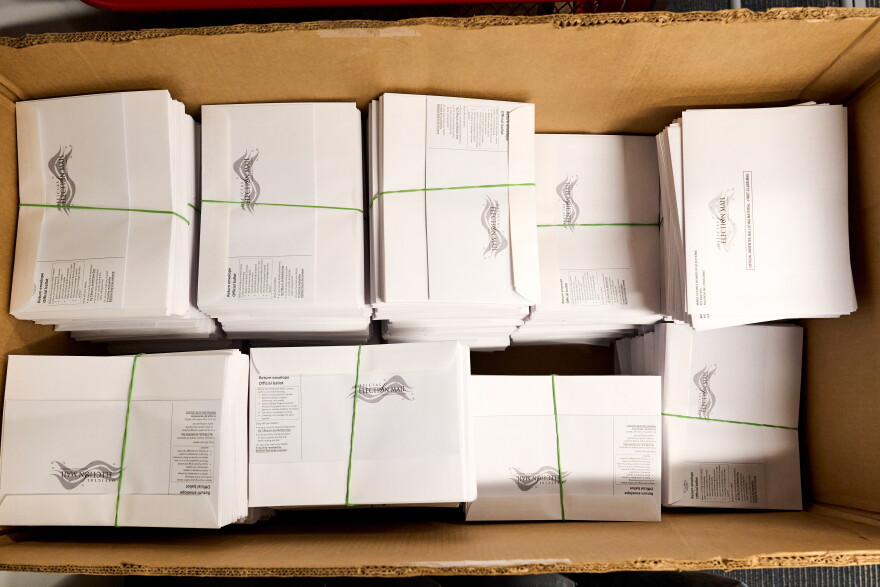 A large box of pre-assembled mail-in ballots
