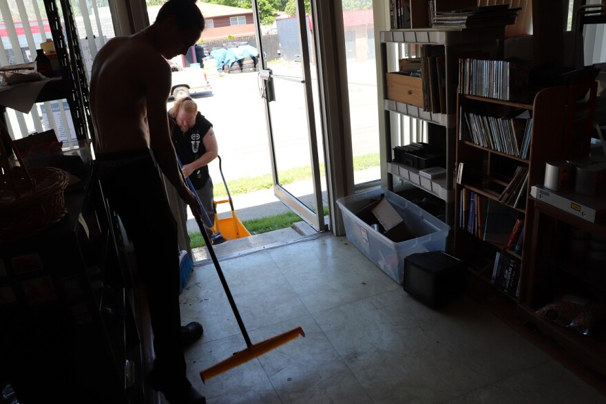 Men sweeping shattered glass