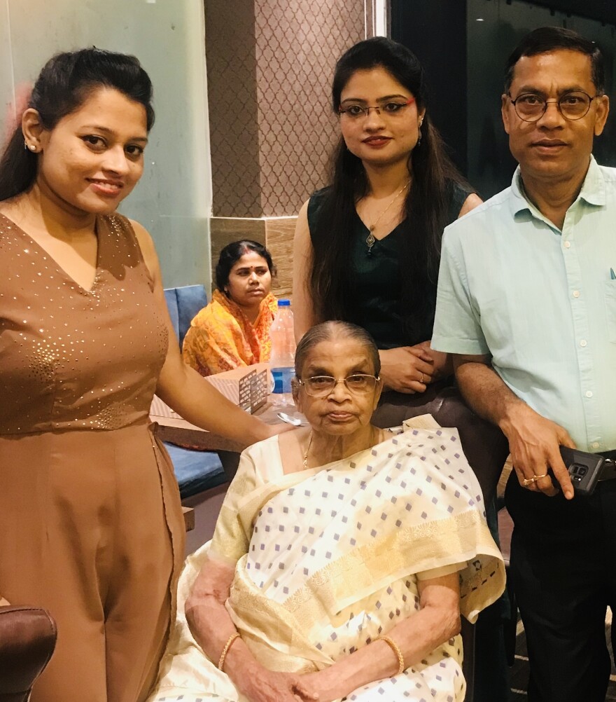Manas Ray's brother, Kajal, and their mother, Bandana, seated in front. Kajal and his twin daughters, Puja and Lija, (standing) and a nurse (seated in background) have helped care for Bandana in Bardhaman, India.
