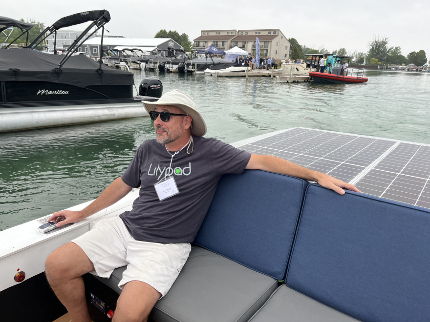 Jim Hotary of Lilypad Labs steers the solar-powered boat with a joystick control during the Elk Rapids Marina electric boat demo on Aug. 24, 2023.