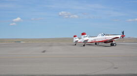 A firefighting plane sits on a runway.