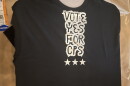 A freshly printed T-shirt reads "Vote Yes for C-P-S."