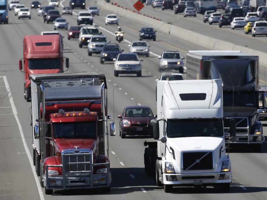 In this Aug. 24, 2016, file photo, truck and automobile traffic mix on Interstate 5, headed north through Fife, Wash., near the Port of Tacoma.