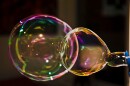One reason bubbles pop so soon is gravity, which causes the liquid to collect at the bottom of the floating bubble.