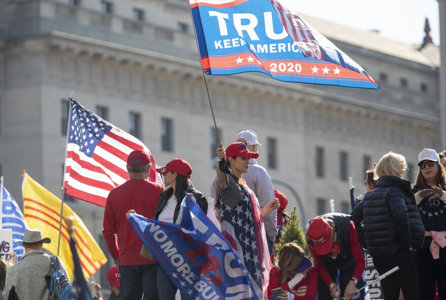 A Trump supporter carries a flag in Washington, D.C.