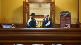 A man talks to another man.