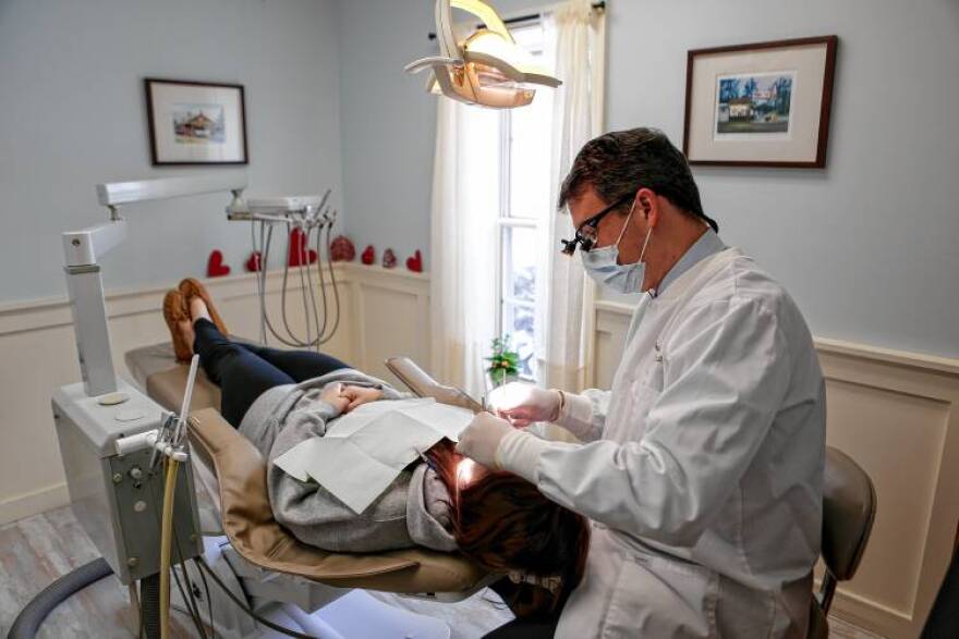 At his Easthampton, Massachusetts, practice, Dr. Thomas Cleary works with patient Ally Rossi of Westfield on Feb. 8, 2017.