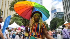 The Rev. Lasasha Johnson strikes a pose on South Tryon Street during the Charlotte Pride festival on Aug. 20.