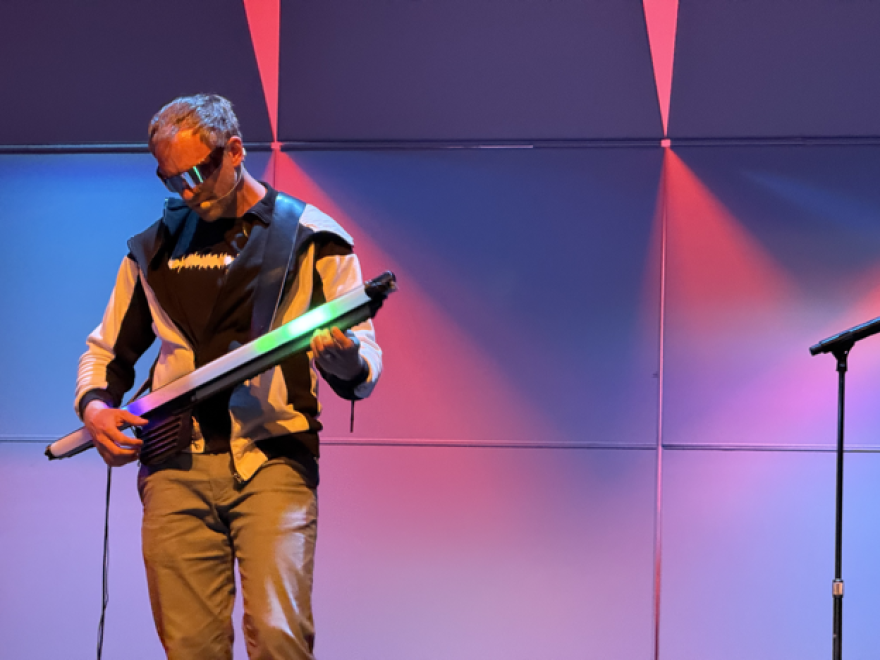 Chet Udell plays the Optron on January 19, 2026. The Optron is a unique instrument developed by Udell described as if “a lightsaber and a guitar had a baby”.