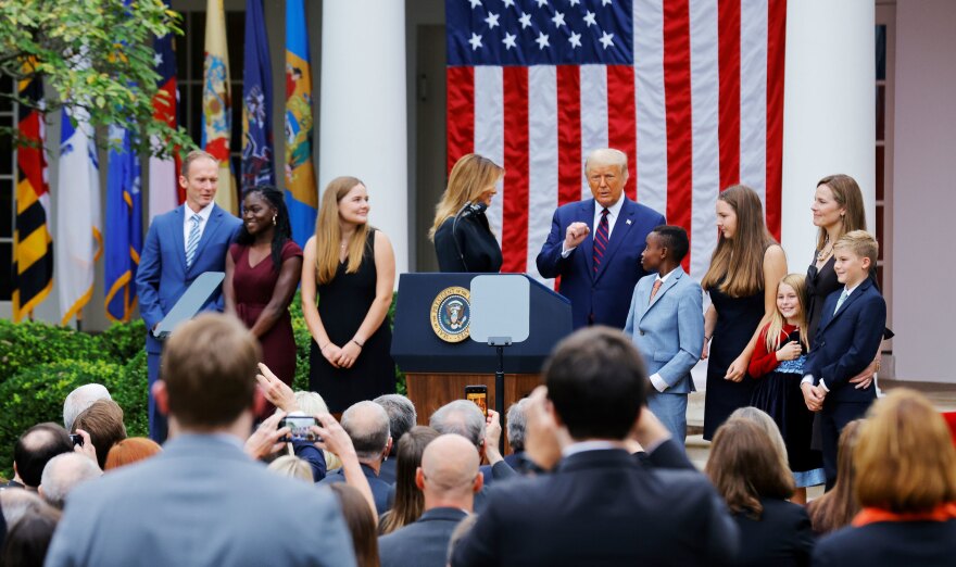 President Trump poses with Supreme Court nominee Amy Coney Barrett and her family at an event to announce her as his nominee on Saturday.