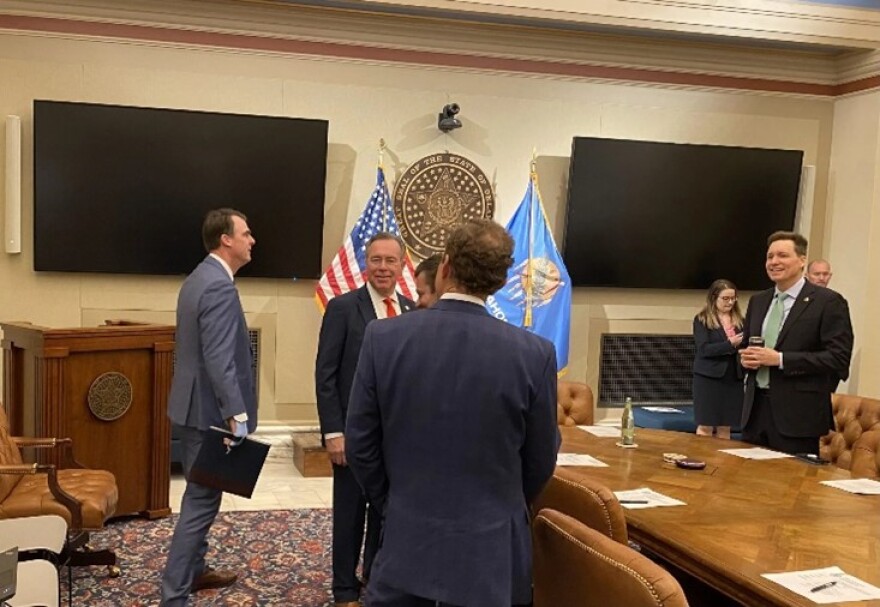 Oklahoma Gov. Kevin Stitt, left, gets ready for a meeting of the newly formed Invest in Oklahoma board at the Capitol in Oklahoma City on Tuesday, Feb. 17, 2026. Also shown are Treasurer Todd Russ and Lt. Gov. Matt Pinnell.