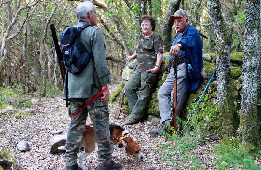 Hunters gather prior to a wild boar hunt in Pietrosella, on the French Mediterranean island of Corsica, in August.