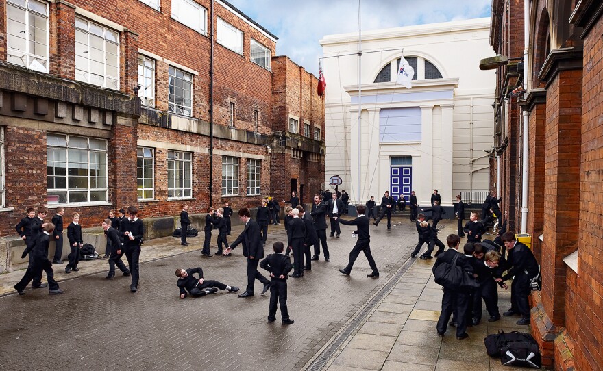 Teens take a break on a courtyard between classes at Hull Trinity House Academy, an all-boys school in the U.K.