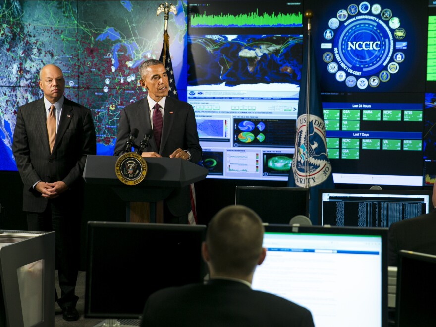 President Obama, joined by Homeland Security Secretary Jeh Johnson (left), delivers remarks at the National Cybersecurity and Communications Integration Center on Jan. 13 in Arlington, Va. Obama discussed efforts to improve the government's ability to collaborate with industry to combat cyber threats.